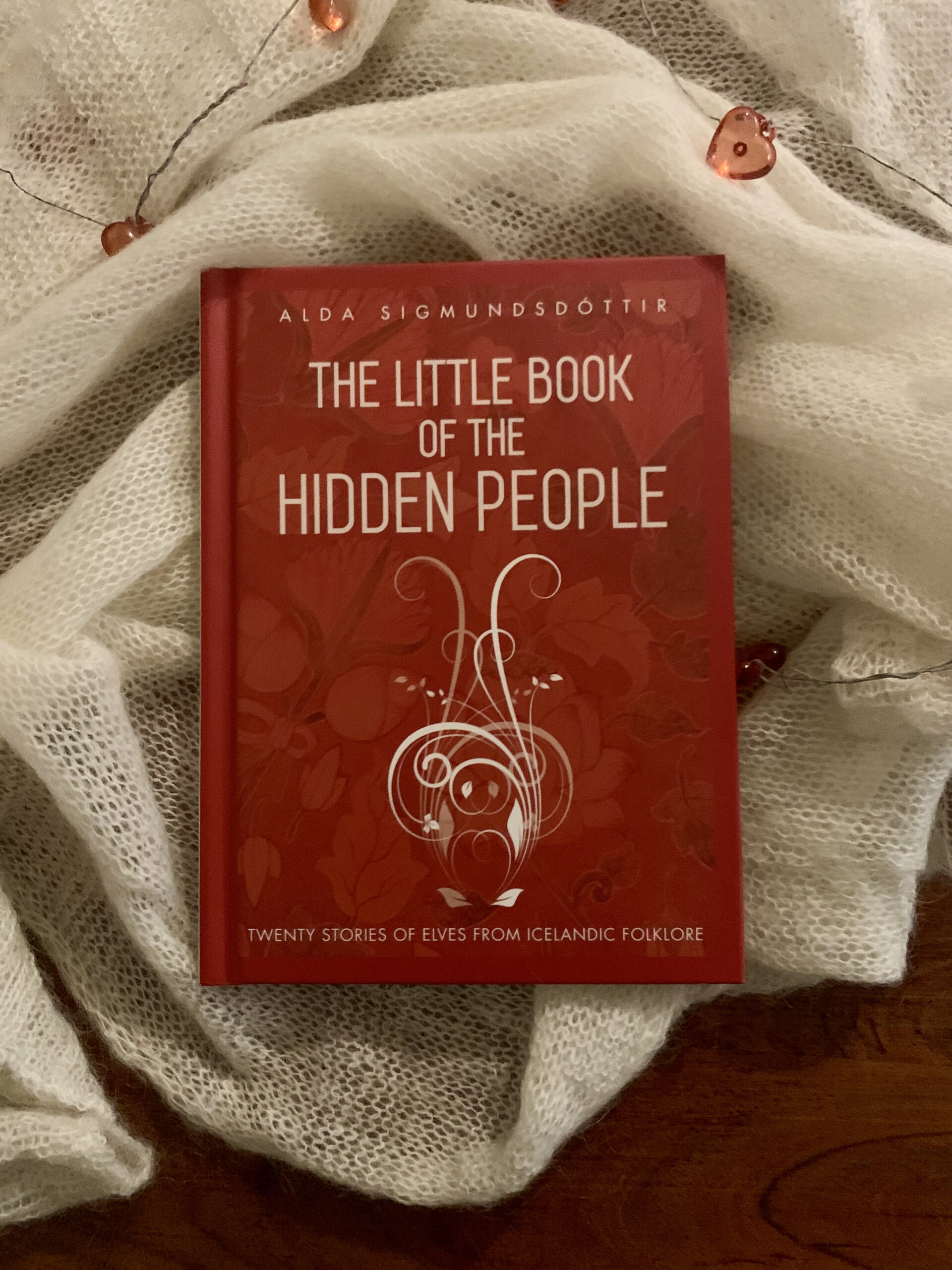 Hardcover copy of The Little Book of the Hidden People lying on a cloth